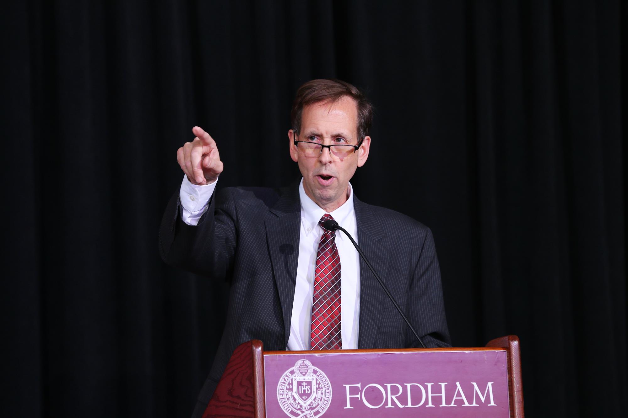 DiBari pointing at a podium
